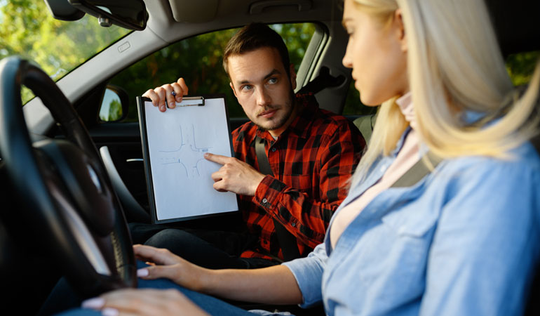 Mobile roadworthy inspector speaking beside a passenger vehicle