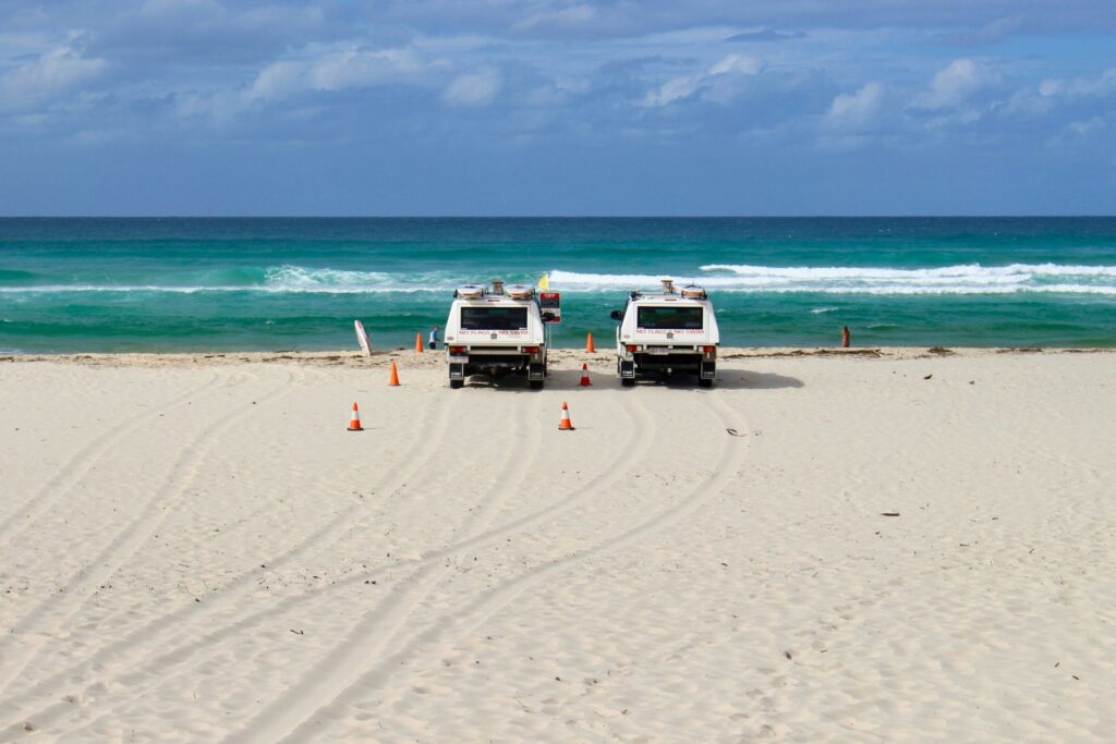 Two cars in the sea shore with the view of the beatiful Palm Beach