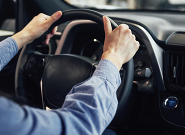 man holding the steering wheel