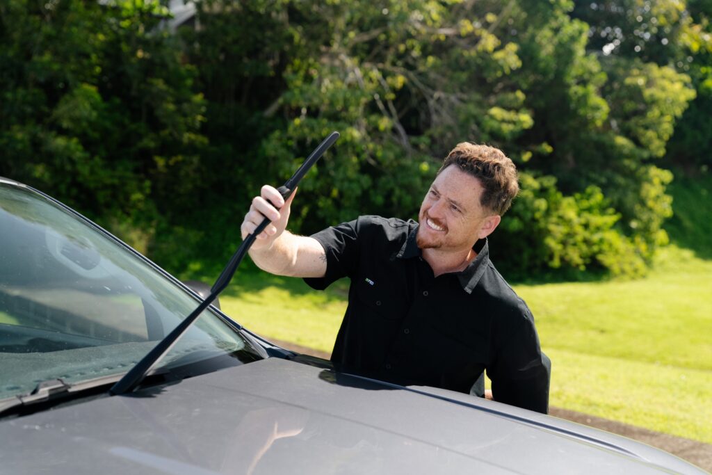 Inspector checking a windscreen wiper blade – mobile safety certificate in Burleigh Heads