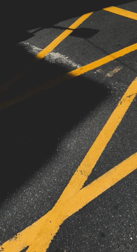 Yellow road line marking on asphalt