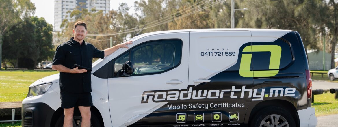Roadworthy.me inspector beside the mobile inspection van with Gold Coast high-rises behind