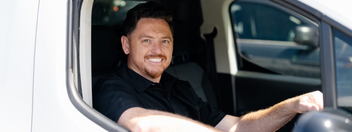 Roadworthy.me inspector smiling from the driver seat of the mobile van, ready for a QLD COI inspection