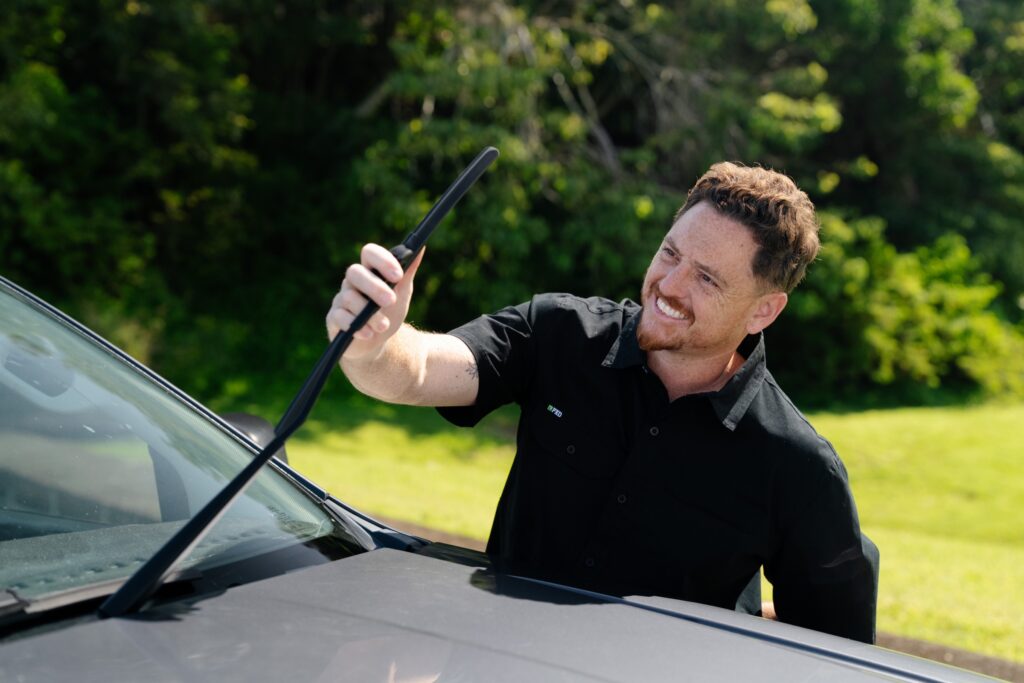 Inspector checking a windscreen wiper blade during a QLD safety certificate inspection