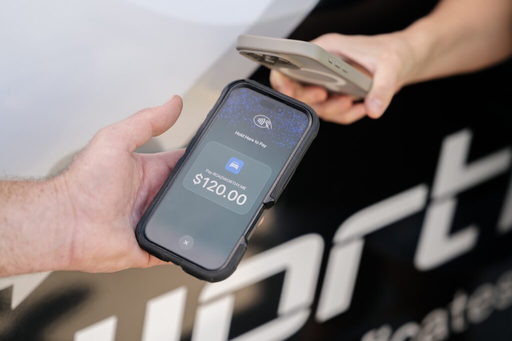 Customer paying by tap-to-pay for a same-day Gold Coast safety certificate inspection