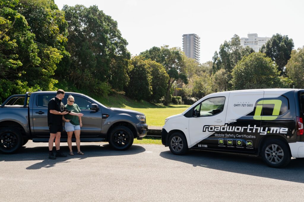 Roadworthy.me inspector talking with a customer beside the ute – safety certificate in Tugun